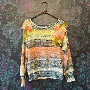 Multicolored Anthropologie sweater with shoulder fringe.